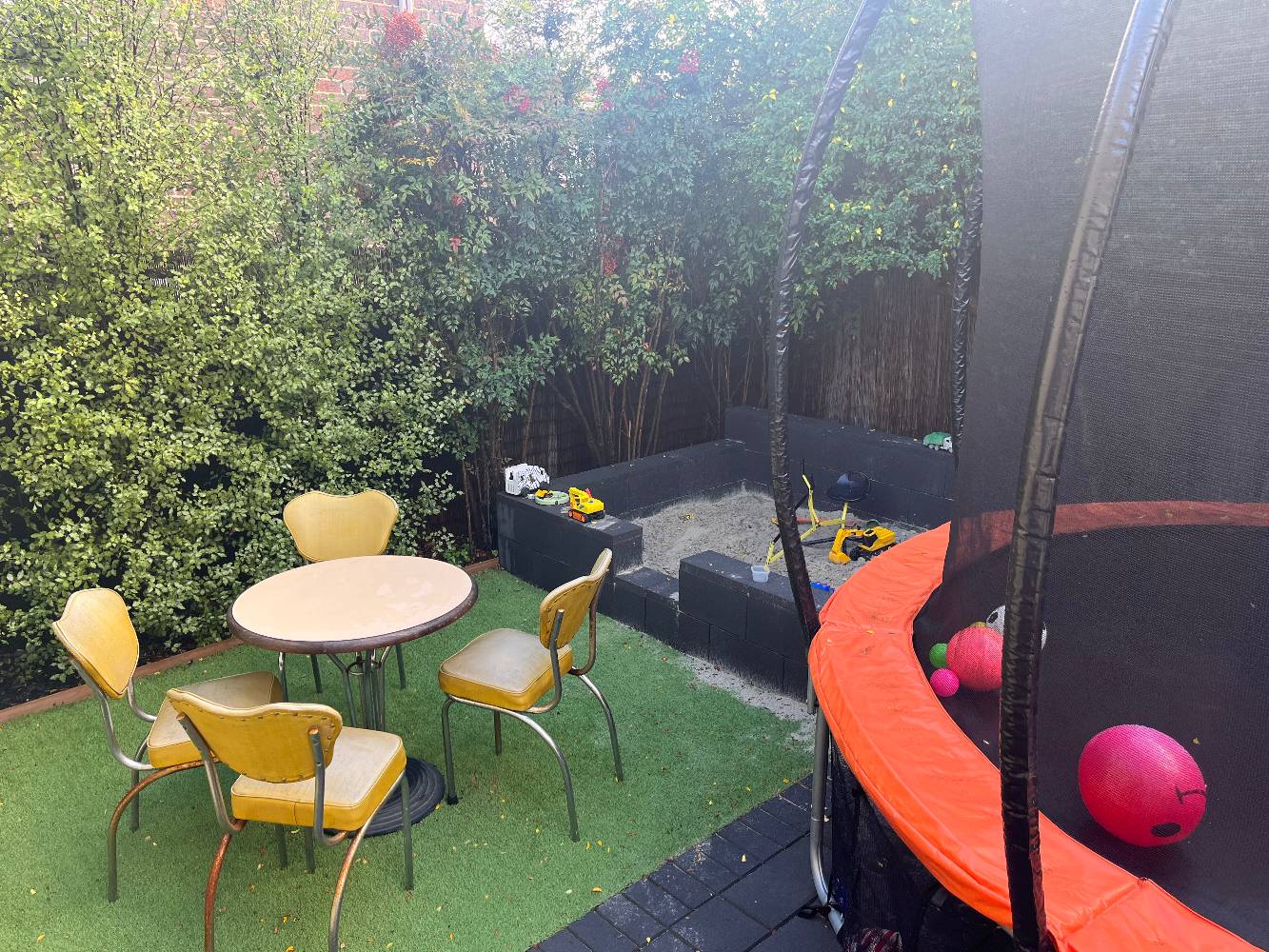Courtyard with trampoline and sandpit