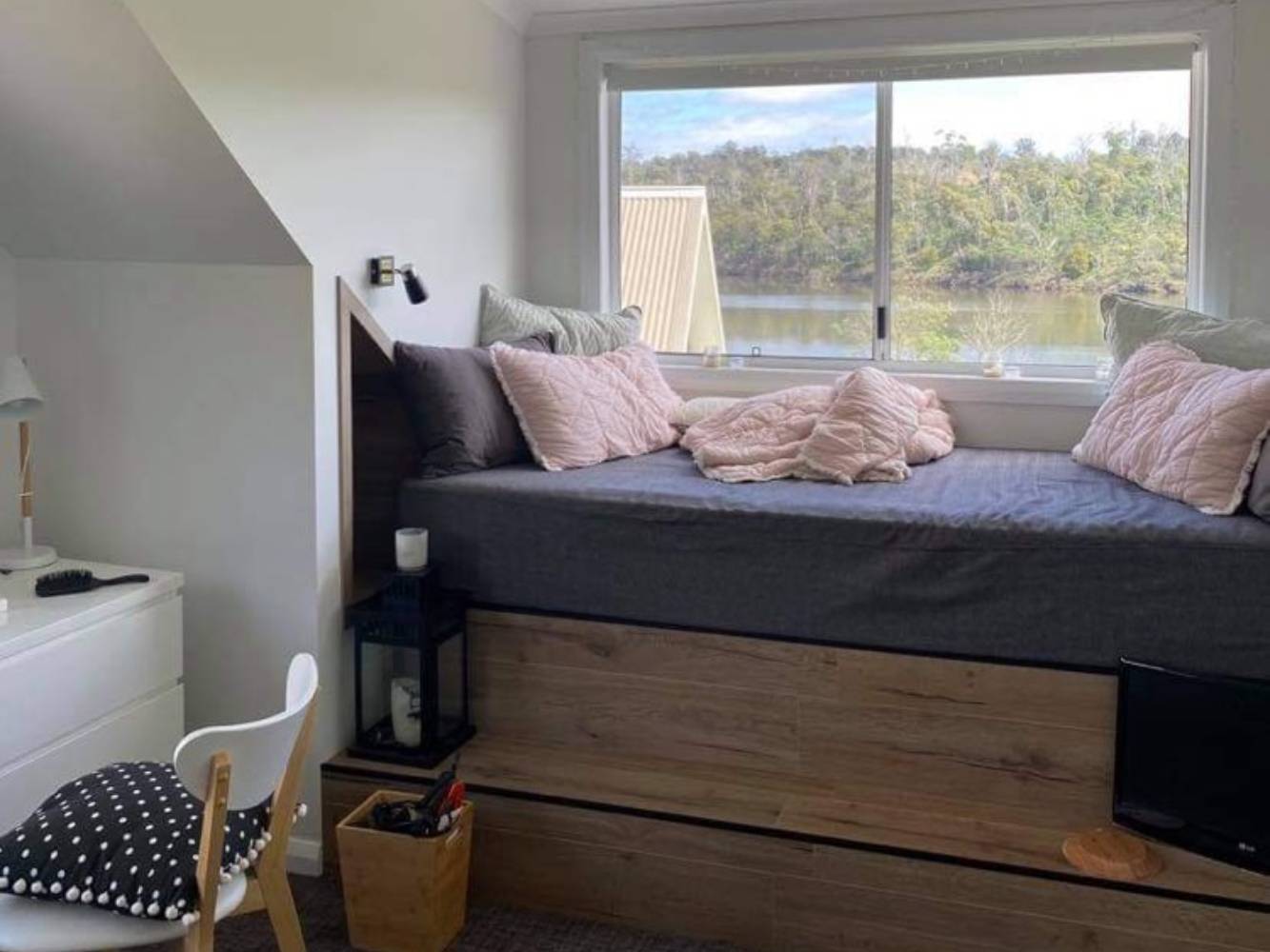 2nd bedroom with comfy window seat perfect for taking in our river views or reading a book.