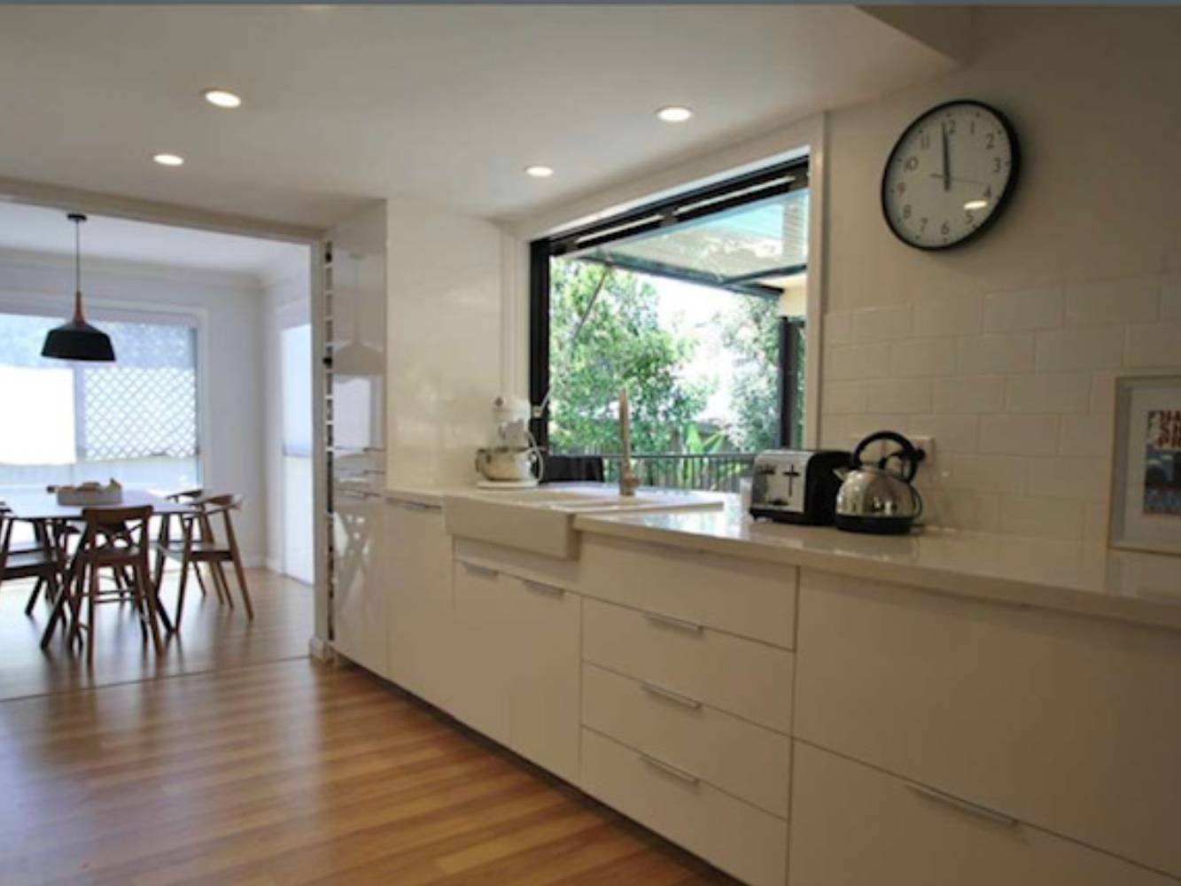 Kitchen benchtop area with hatch window overlooking the pool