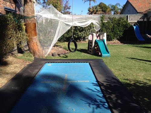 In-ground Trampoline, slide in background RHS Backyard