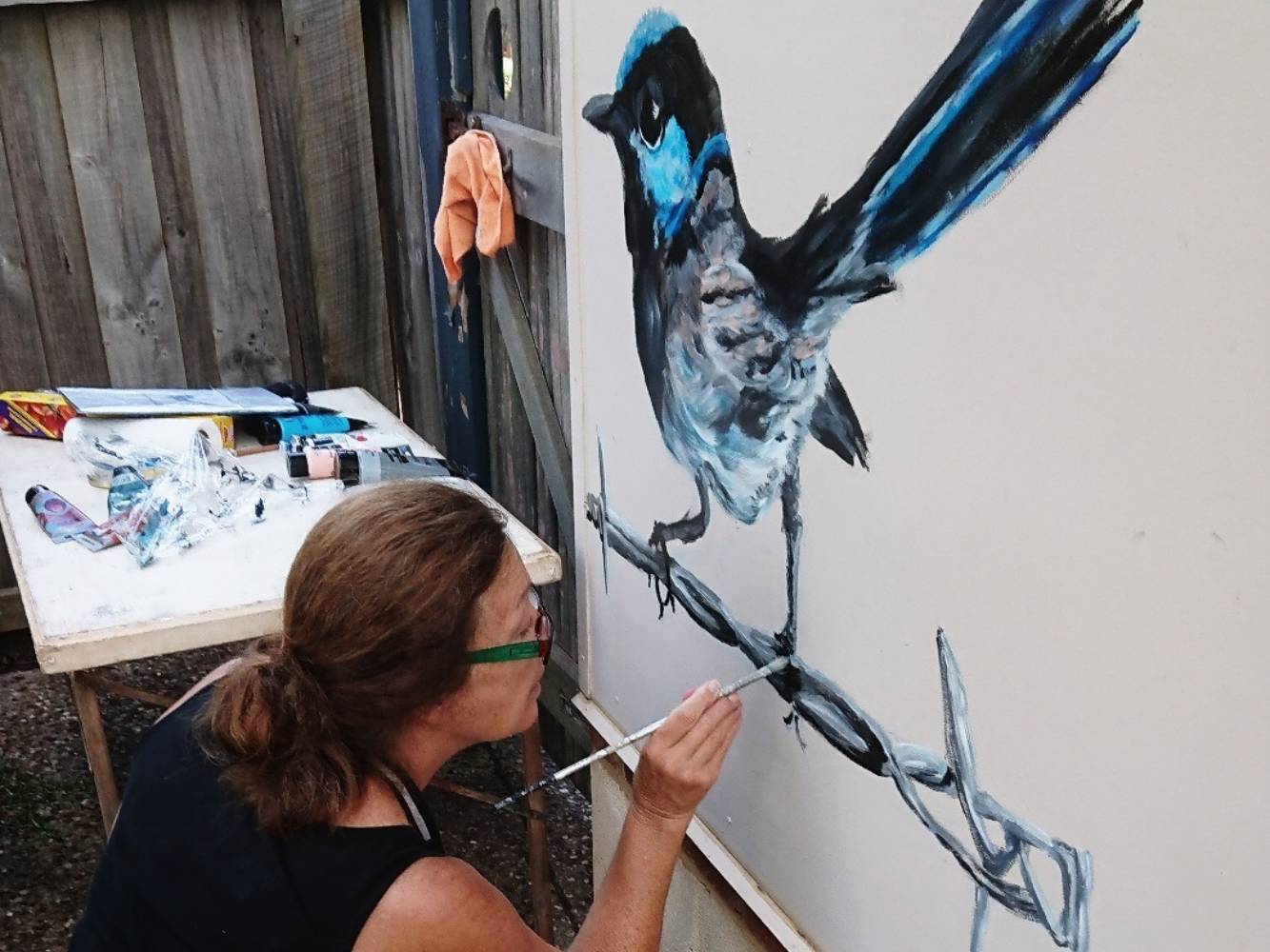 Me painting on the studio outside wall