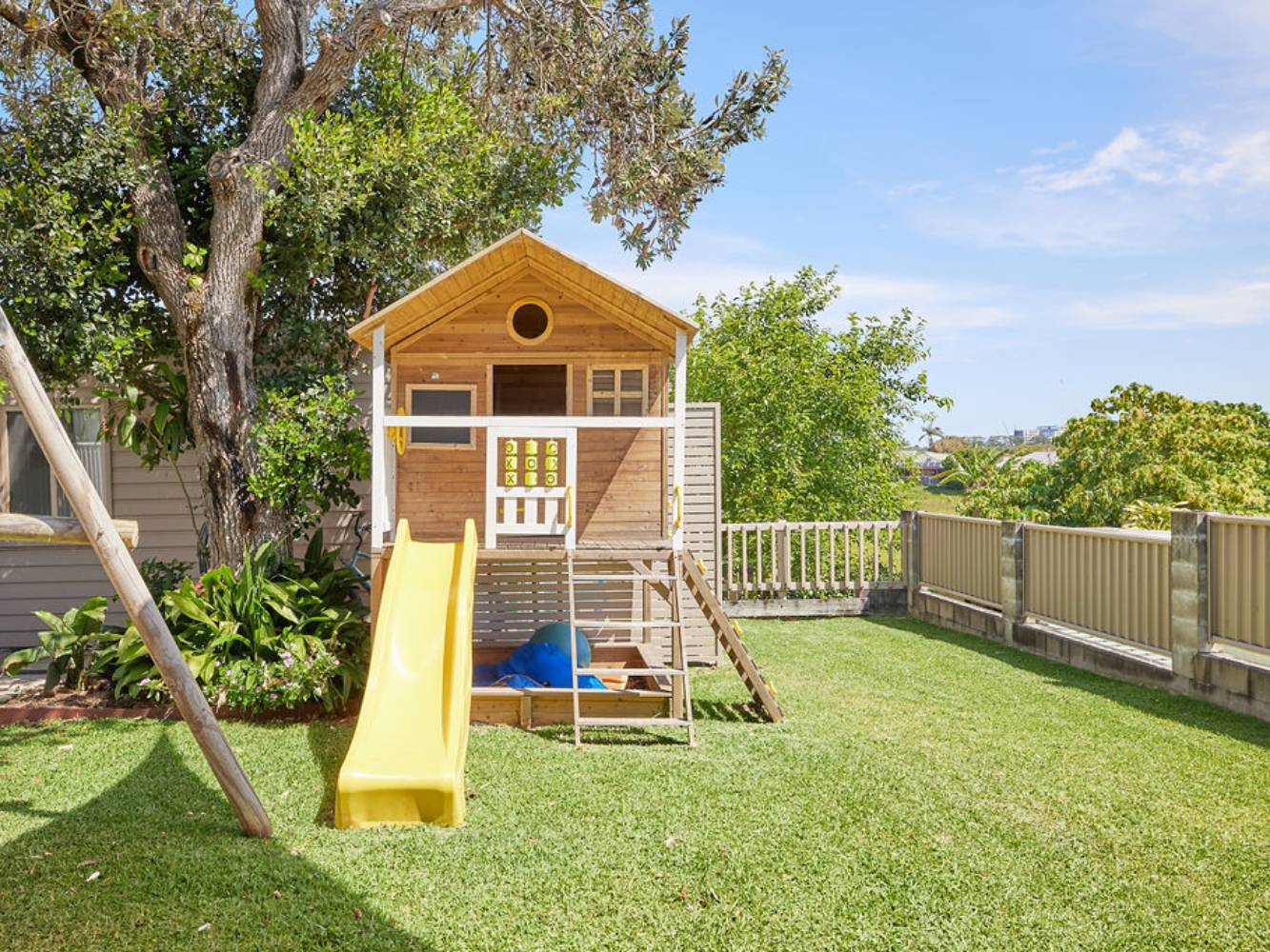Large backyard and swing set and cubby house