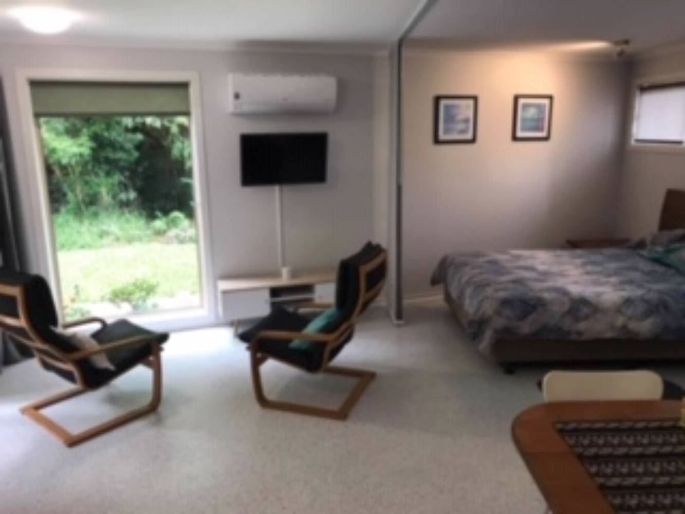 Open plan living with privacy screen & window coverings.